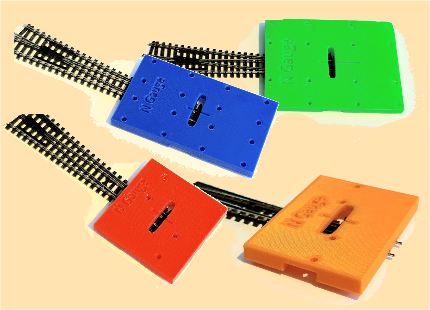 Colour coded point motor fitting jigs for different types of points in four different gauges